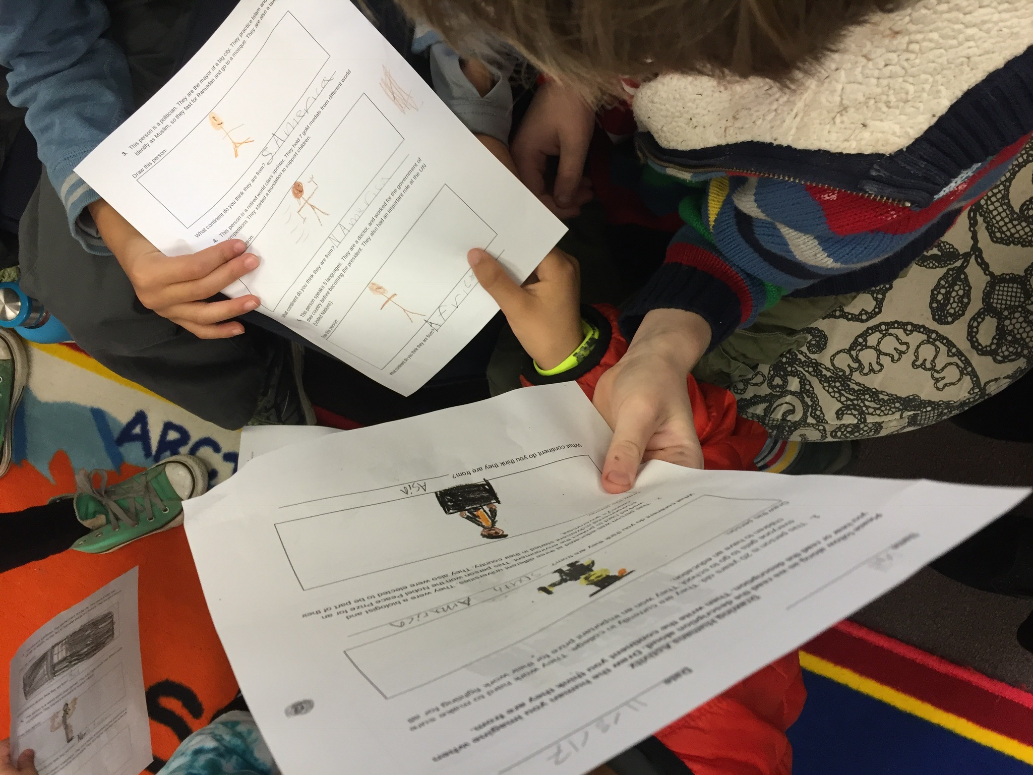  Students comparing responses and discussing their thinking process 