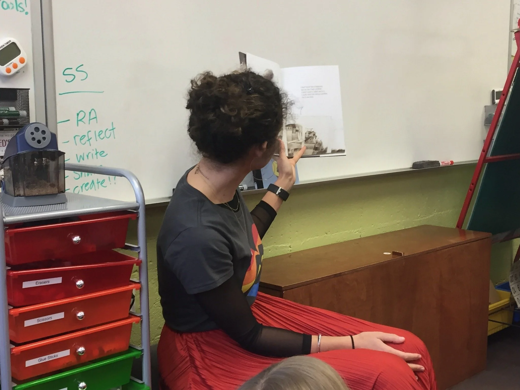  Gabby reading a book aloud to some third graders. 